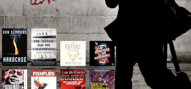 Man walking by a wall with book covers on it